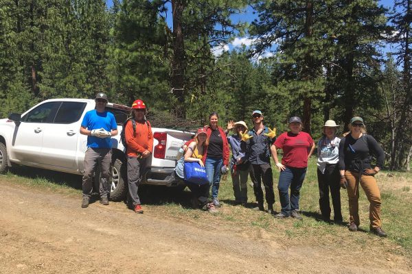 volunteers removing unwanted fencing during stewardship day event