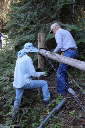 two volunteers repairing fence in the Monument